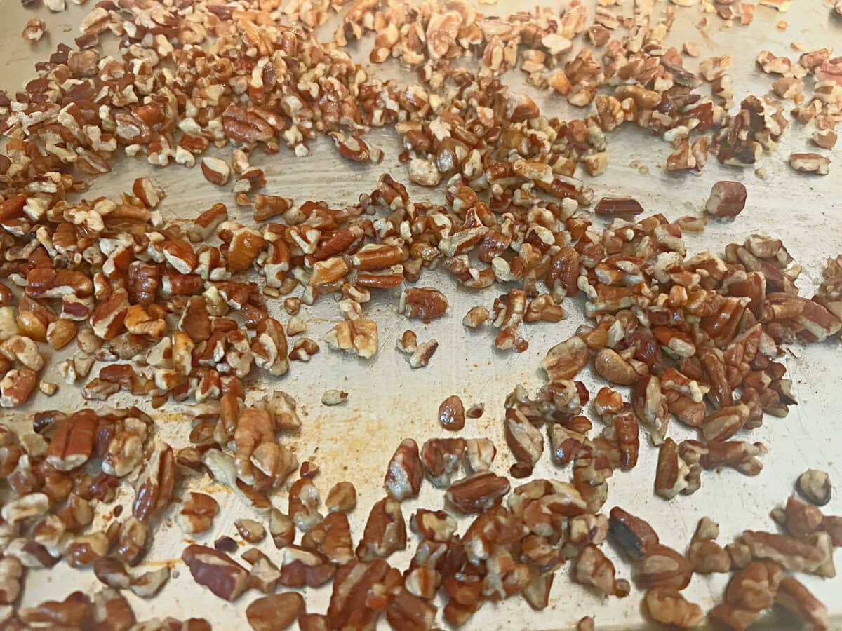 Roasted pecans on a cookie sheet.