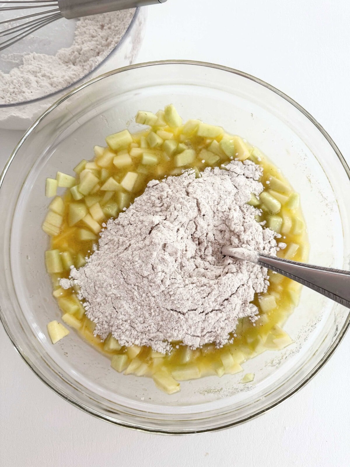 Stirring flour into the batter for Apple Snack Cake.