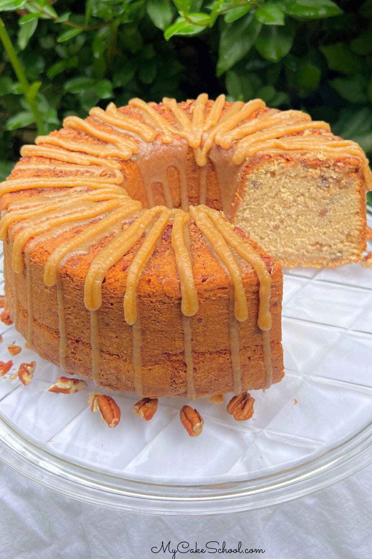Pecan Spice Pound Cake Recipe, sliced, on a cake plate.