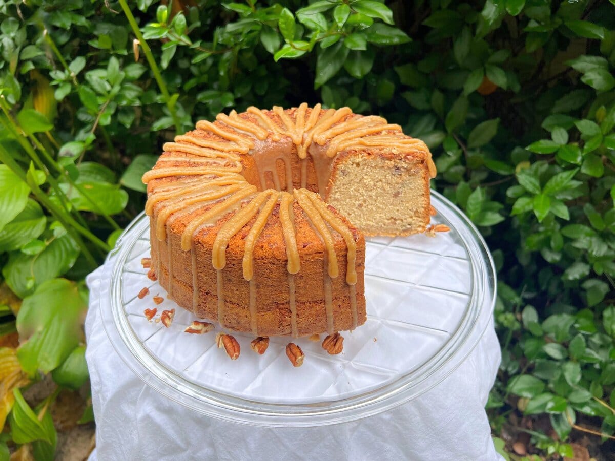 Pecan Spice Pound Cake, sliced, on a cake plate. 