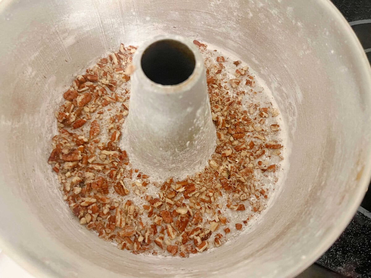Pecans sprinkled in the bottom of a prepared bundt pan.