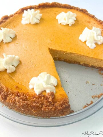 Pumpkin Cheesecake, sliced, on a cake plate.