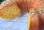Apple Rum Cake, sliced, on a cake pedestal.