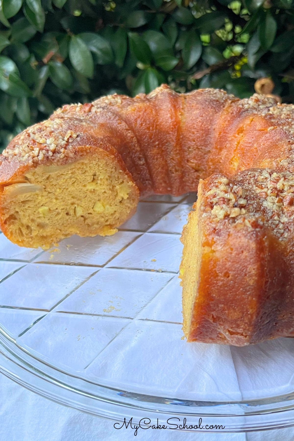 Apple Rum Cake, sliced, on a cake pedestal.