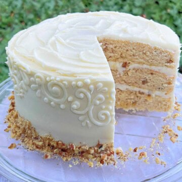Maple Walnut Cake, sliced, on a cake platter.