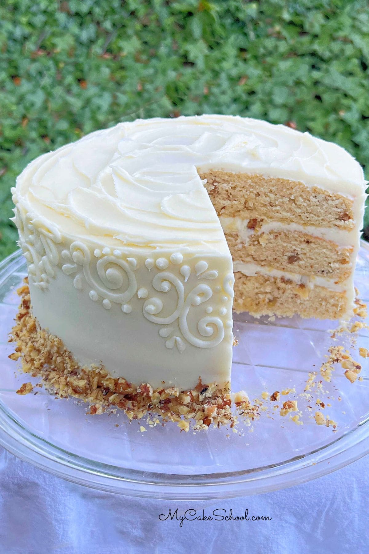 Maple Walnut Cake, sliced, on a cake platter.