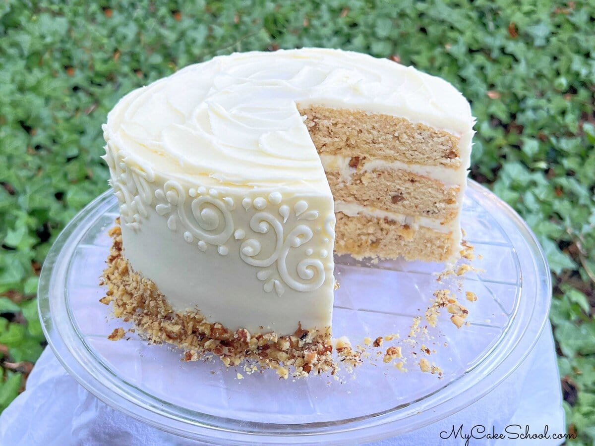 Maple Walnut Cake, sliced, on a cake plate.