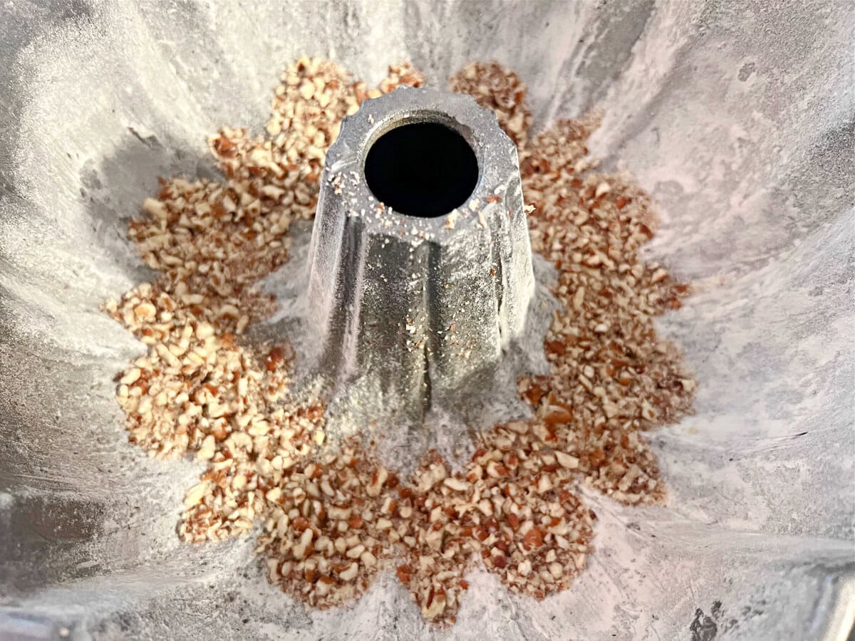 Bundt Pan sprinkled with crushed pecans.