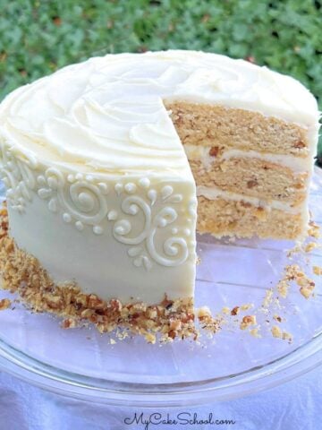 Maple Walnut Cake, sliced, on a cake plate.