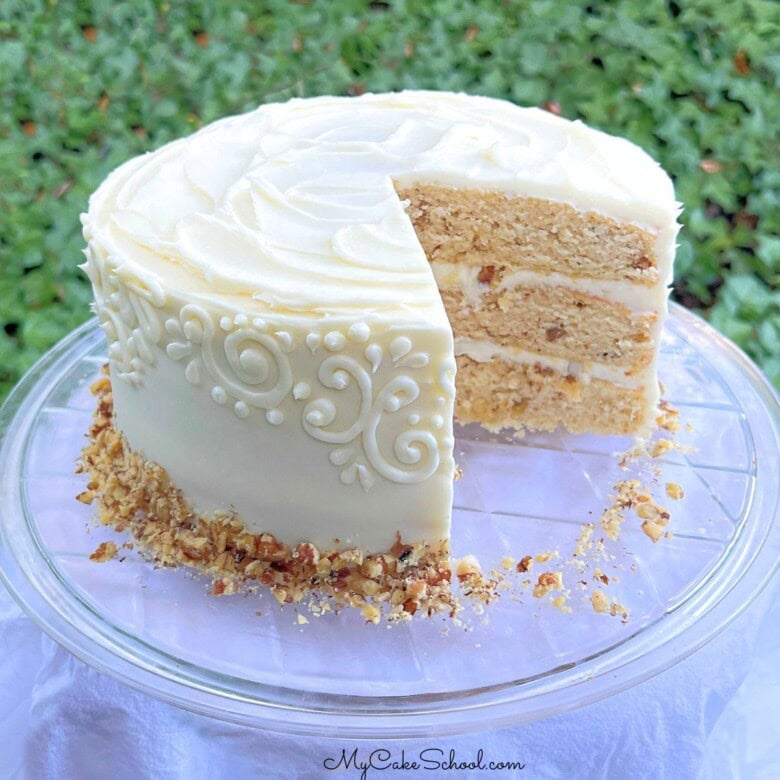 Maple Walnut Cake, sliced, on a cake plate.