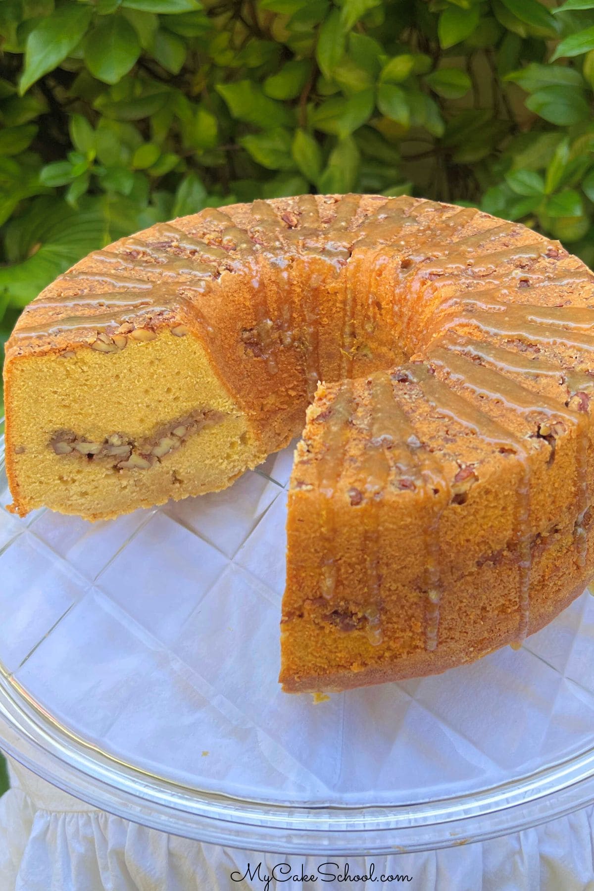 Sweet Potato Pecan Pound Cake, sliced, on a cake plate.