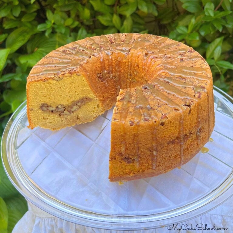 Decadent Sweet Potato Pecan Pound Cake on a cake plate.