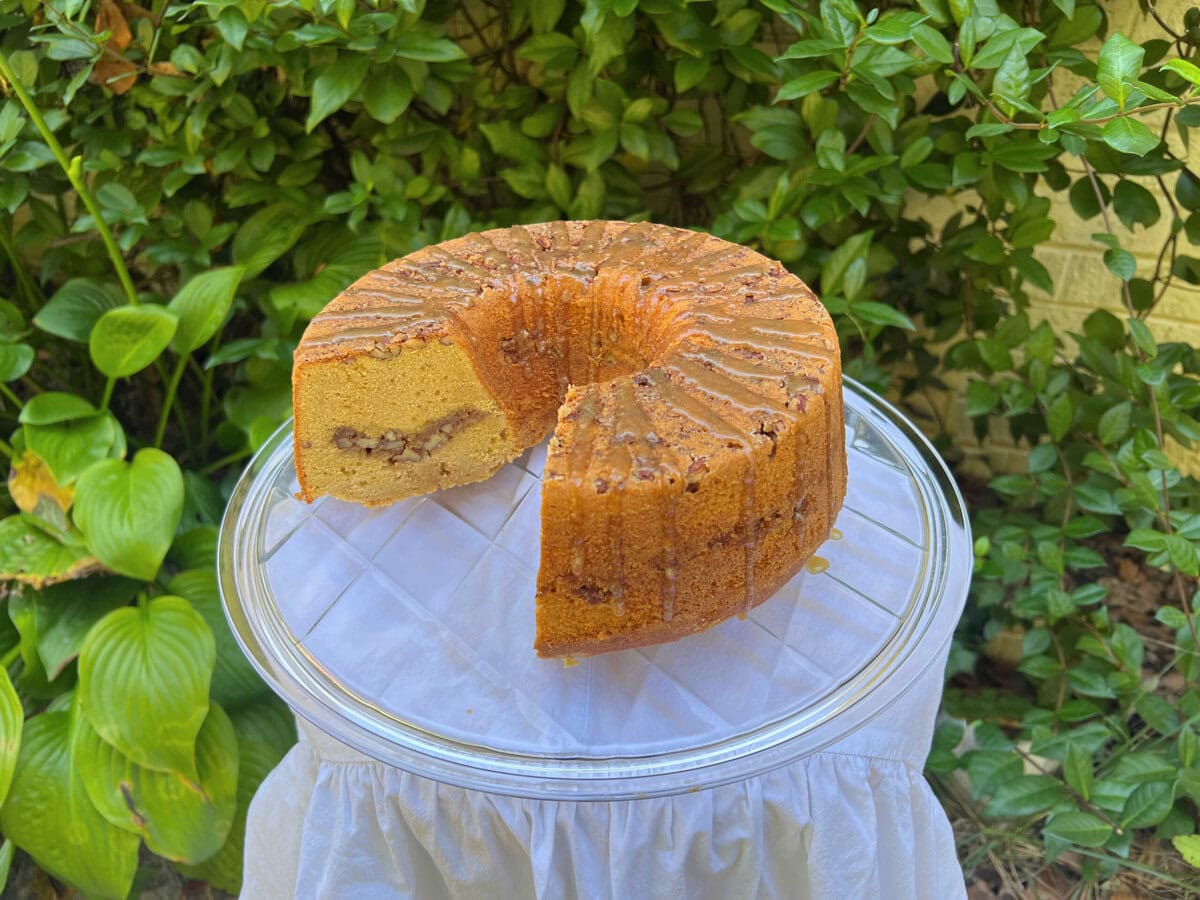 Sweet Potato Pecan Cake, sliced, on a cake plate.