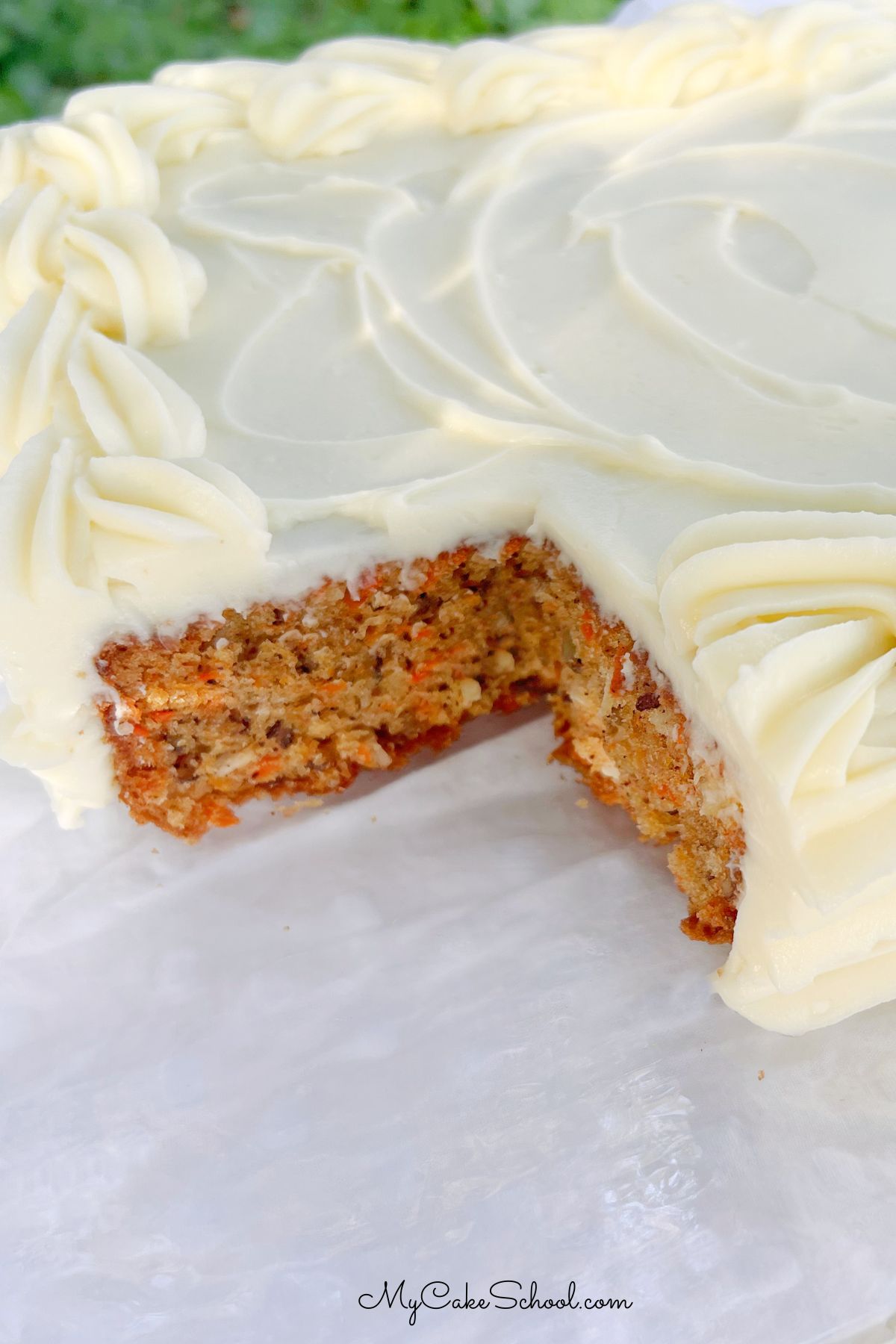 Carrot Sheet Cake, sliced, on a cake plate.