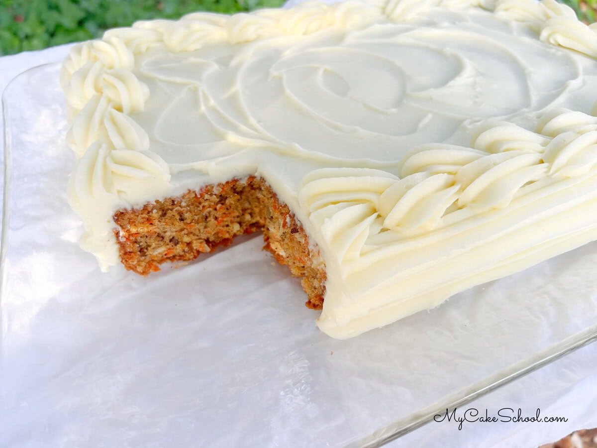 Carrot Sheet Cake, sliced, on a platter.