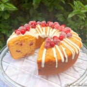Cranberry Orange Pound Cake, sliced, on a cake plate.