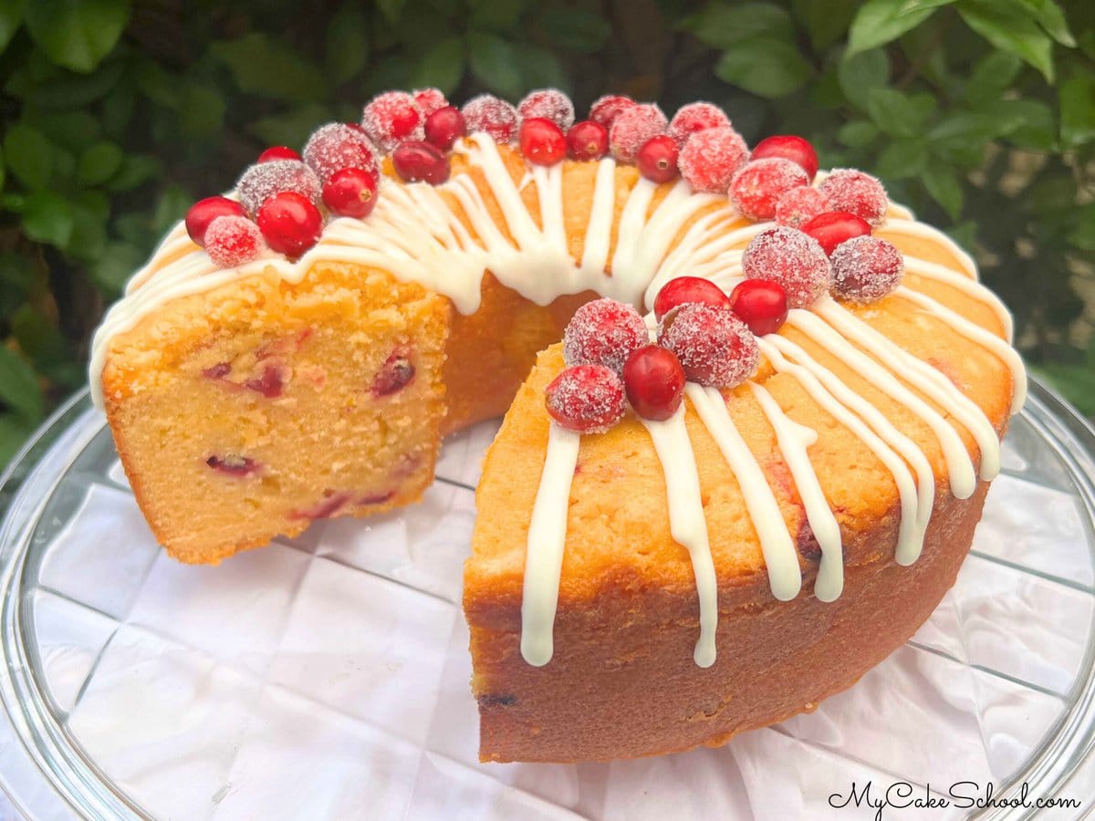 Cranberry Orange Pound Cake, sliced, on a cake plate.