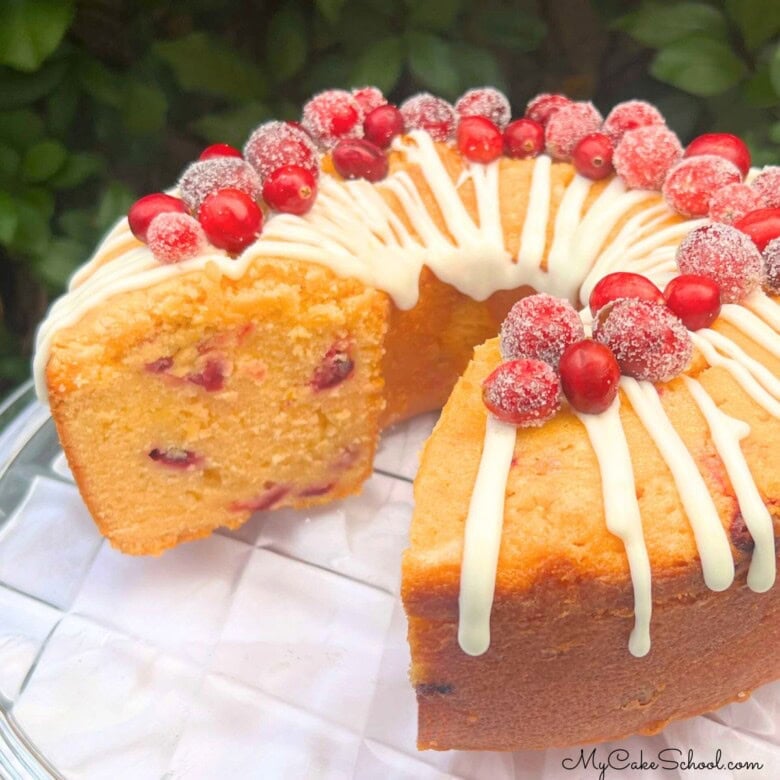 Cranberry Orange Pound Cake, sliced, on a cake plate.
