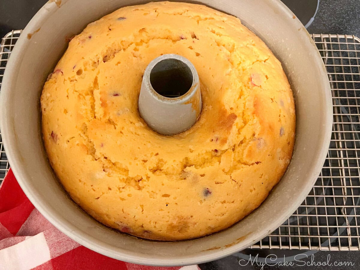 Freshly baked Orange Cranberry Pound Cake, cooling on wire rack.