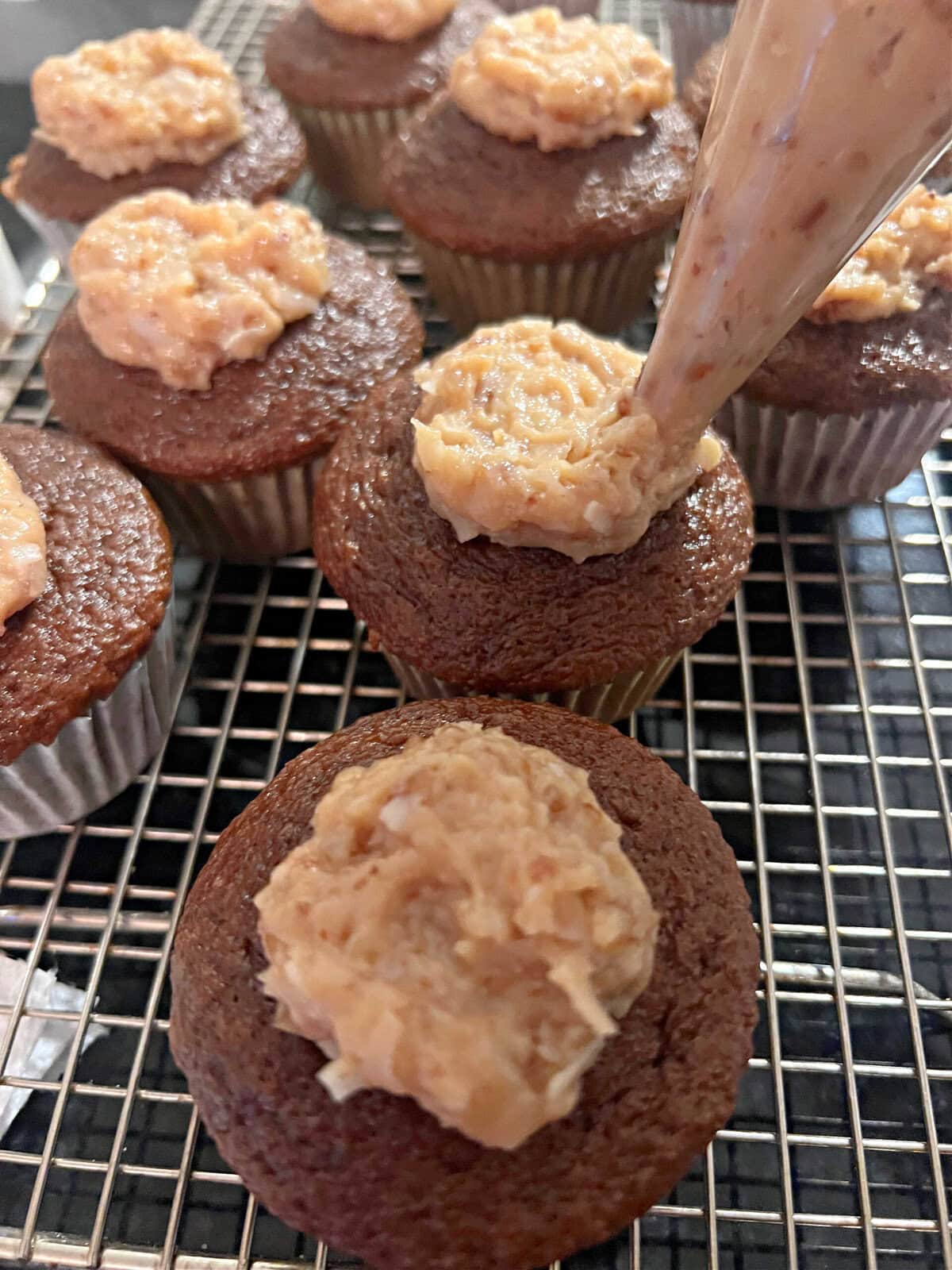 Frosting the German Chocolate Cupcakes.
