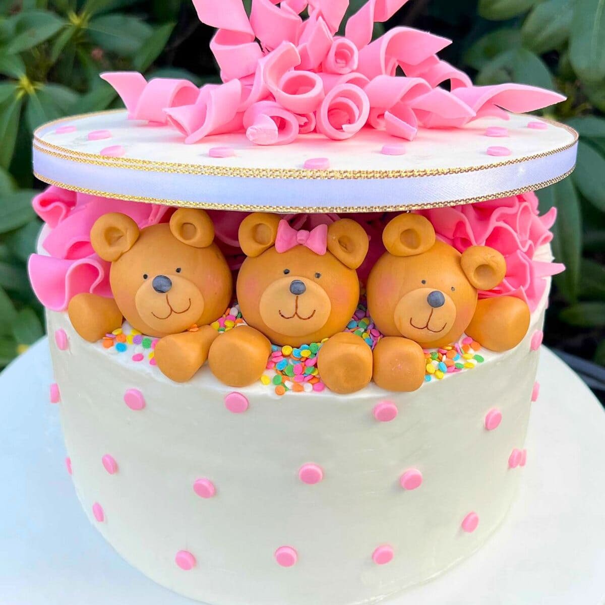 Teddy Bear Gift Cake on white pedestal.