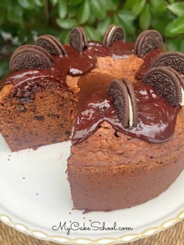 Chocolate Oreo Pound Cake, sliced, on a cake pedestal.