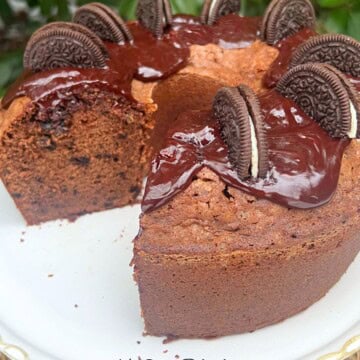 Chocolate Oreo Pound Cake, sliced, on a pedestal.