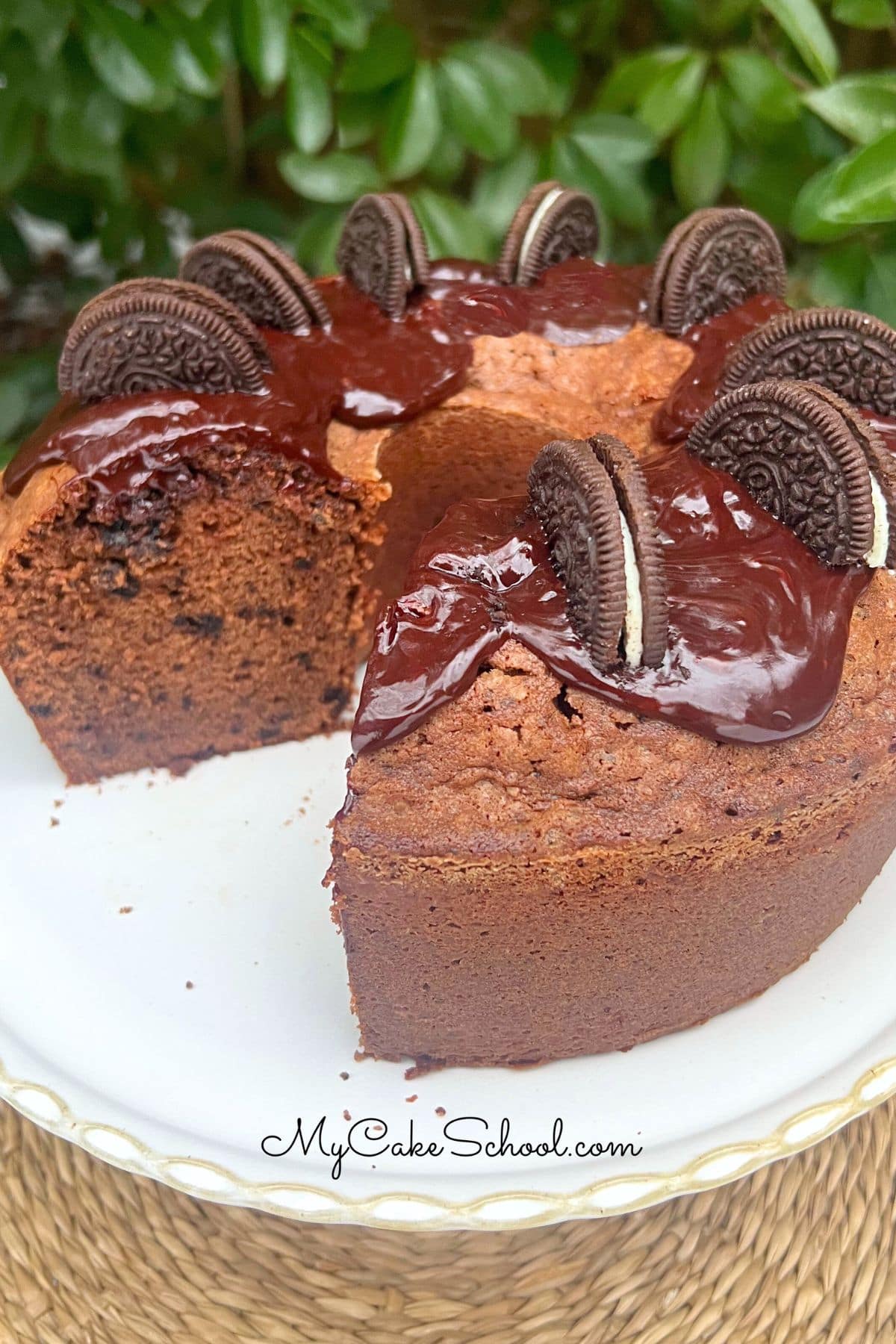 Chocolate Oreo Pound Cake, sliced, on a pedestal.