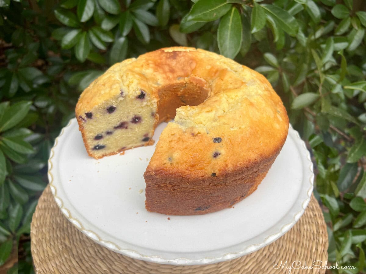 Lemon Blueberry Mascarpone Pound Cake, sliced on a pedestal.