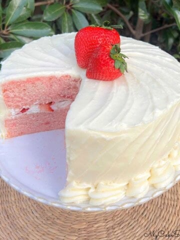 Sliced Strawberry Velvet Cake on a cake pedestal.