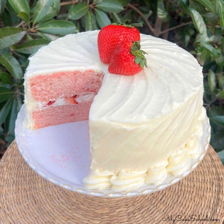 Sliced Strawberry Velvet Cake on a cake pedestal.