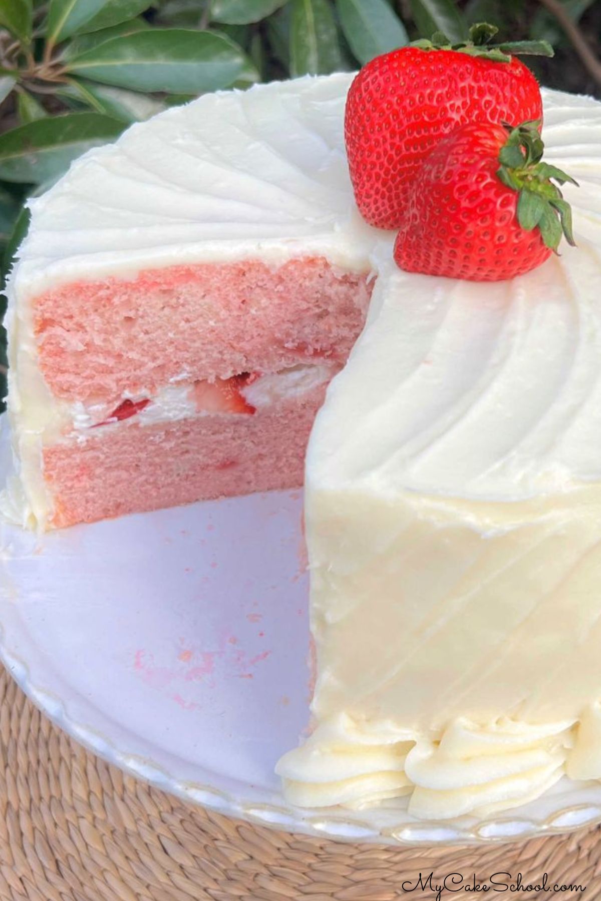 Strawberry Velvet Cake, sliced, on a cake pedestal.
