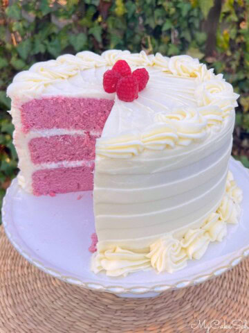 Raspberry Velvet Cake, sliced, on a cake pedestal.