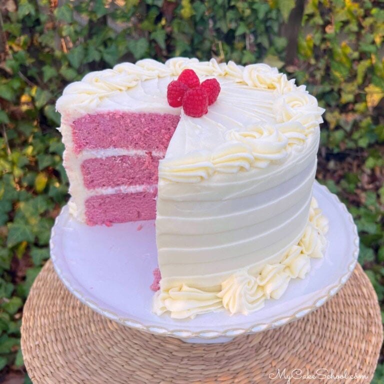 Raspberry Velvet Cake, sliced, on a cake pedestal.