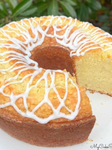 Coconut Whipping Cream Pound Cake, sliced, on a cake pedestal.