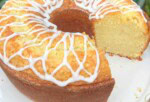 Coconut Whipping Cream Pound Cake, sliced, on a cake pedestal.
