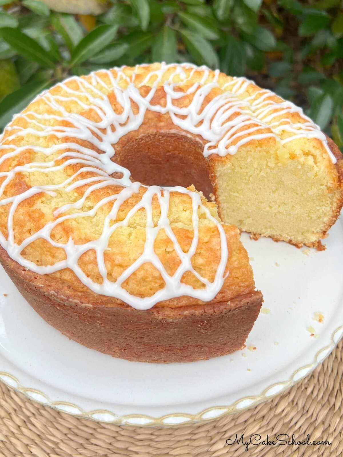 Coconut Whipping Cream Pound Cake, sliced, on a cake pedestal.