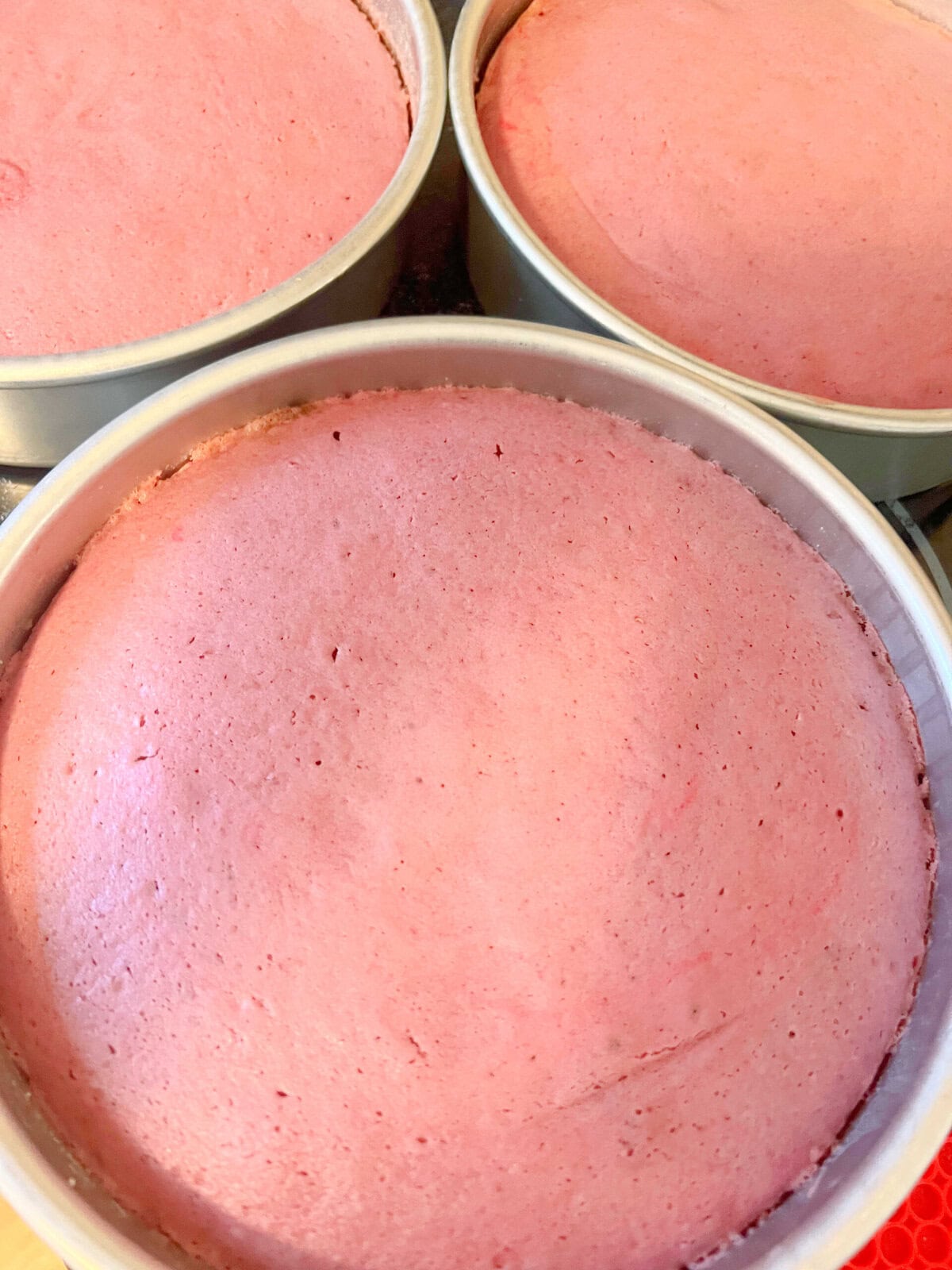 Raspberry Velvet Cake Layers, freshly baked in pans.