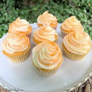 Orange Creamsicle Cupcakes on a cake platter.