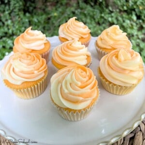 Orange Creamsicle Cupcakes on a cake platter.