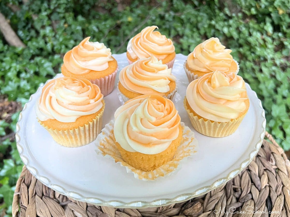 Orange Creamsicle Cupcakes on a pedestal.