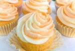 Orange Creamsicle Cupcakes on a pedestal.