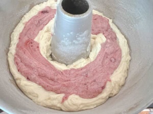 Raspberry batter smoothed over almond batter.