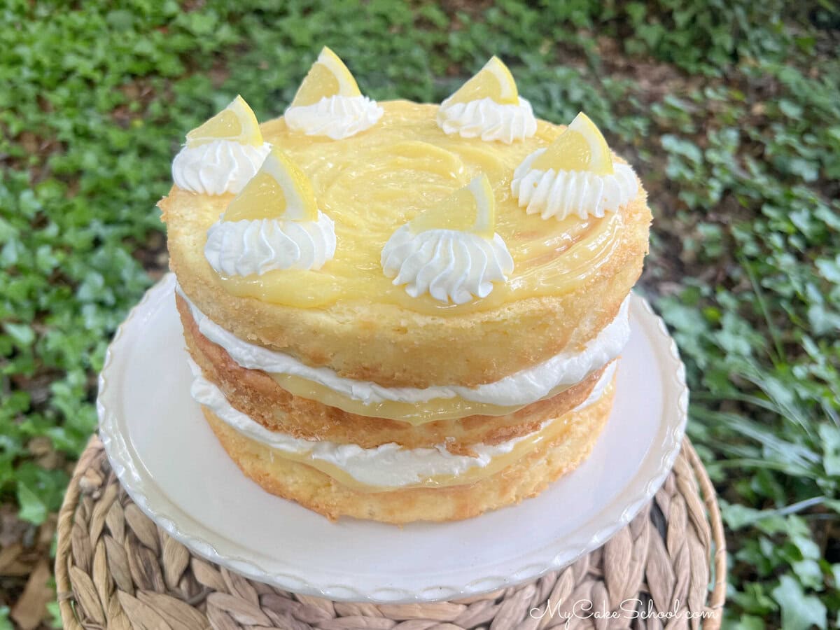 Layered Lemon Cream Cake on a pedestal.
