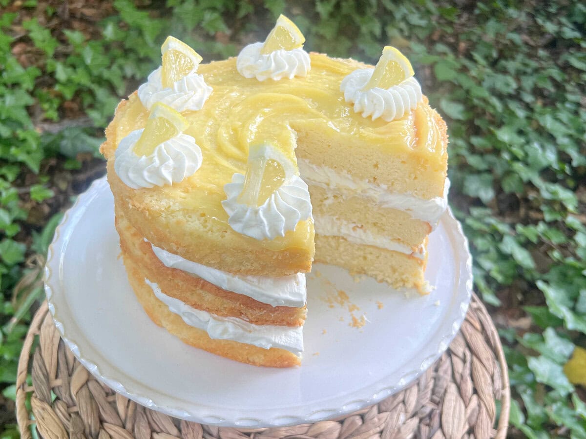 Layered Lemon Cream Cake on a pedestal.