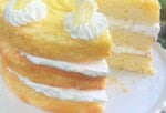 Layered Lemon Cream Cake on a pedestal.