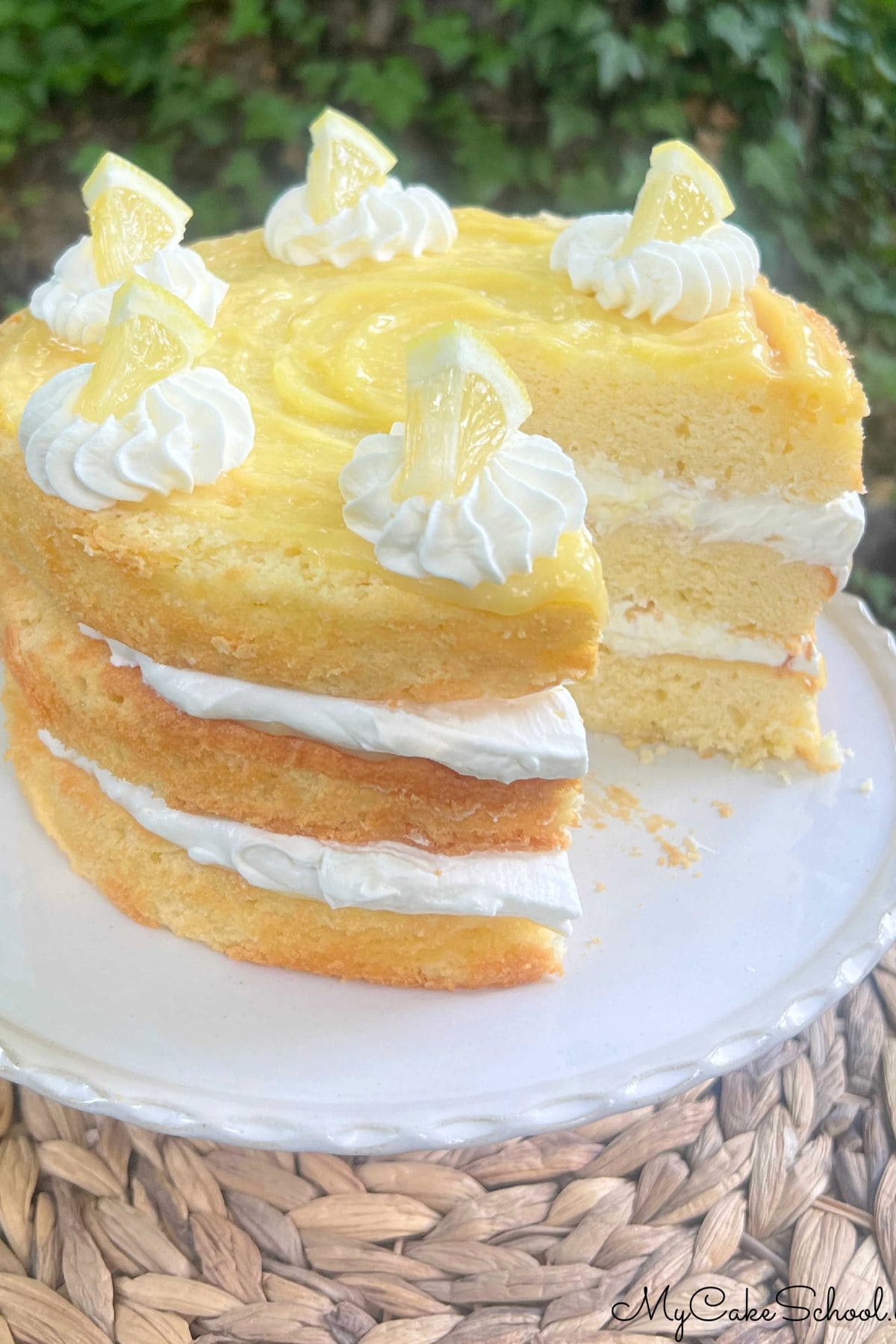 Layered Lemon Cream Cake on a pedestal.