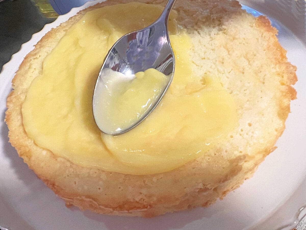 Topping the cake with lemon curd.