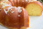 Moist and Rich Limoncello Coconut Bundt Cake on a cake plate, sliced.