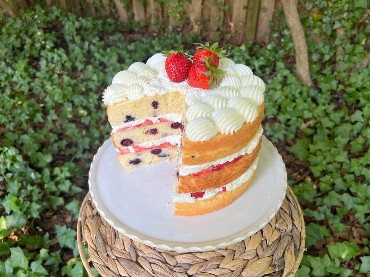 Berry pound cake, sliced, on a cake pedestal.